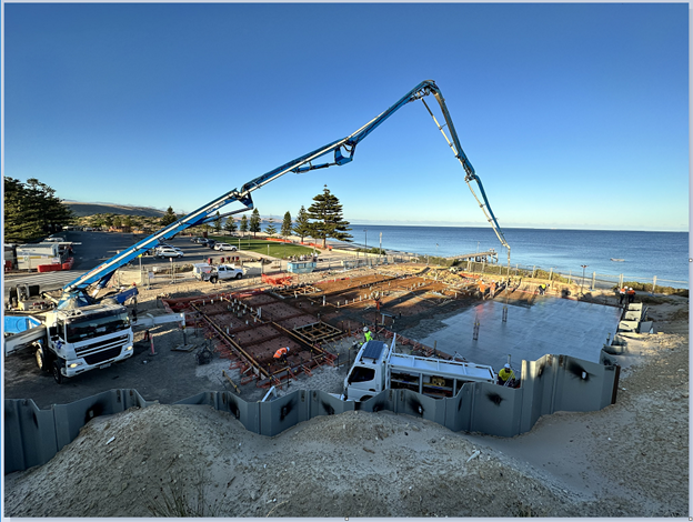 A photo of a concrete truck pouring a slab