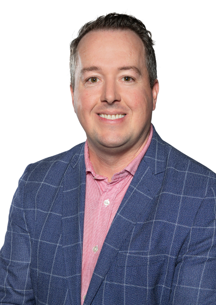 A photo of Nathan Cunningham smiling, with a white background