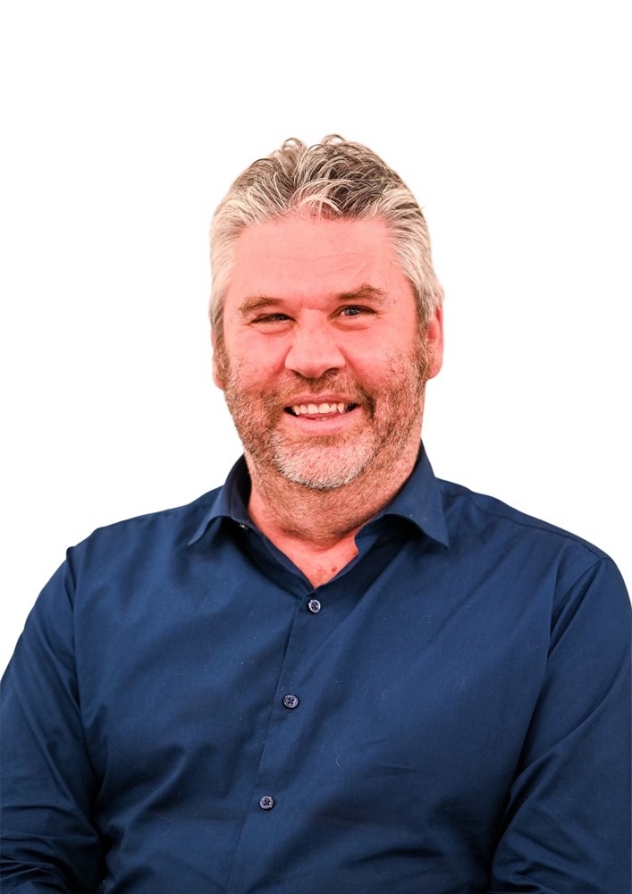 A photo of Mark McLaren smiling, with a white background