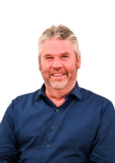 A photo of Mark McLaren smiling, with a white background