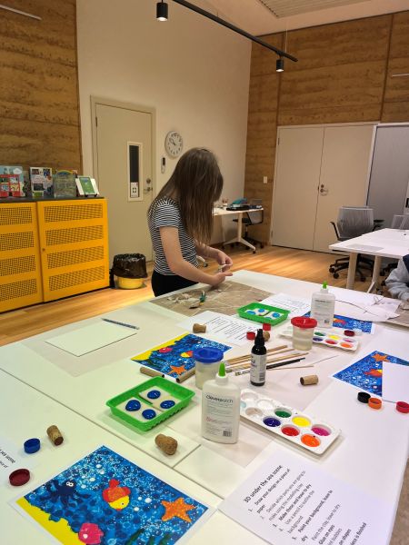 Frances (a little girl) creating a 3D Under the Sea masterpiece at the library