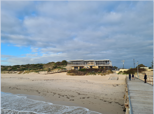 A photo taken from the end of a jetty looking back to the beach.