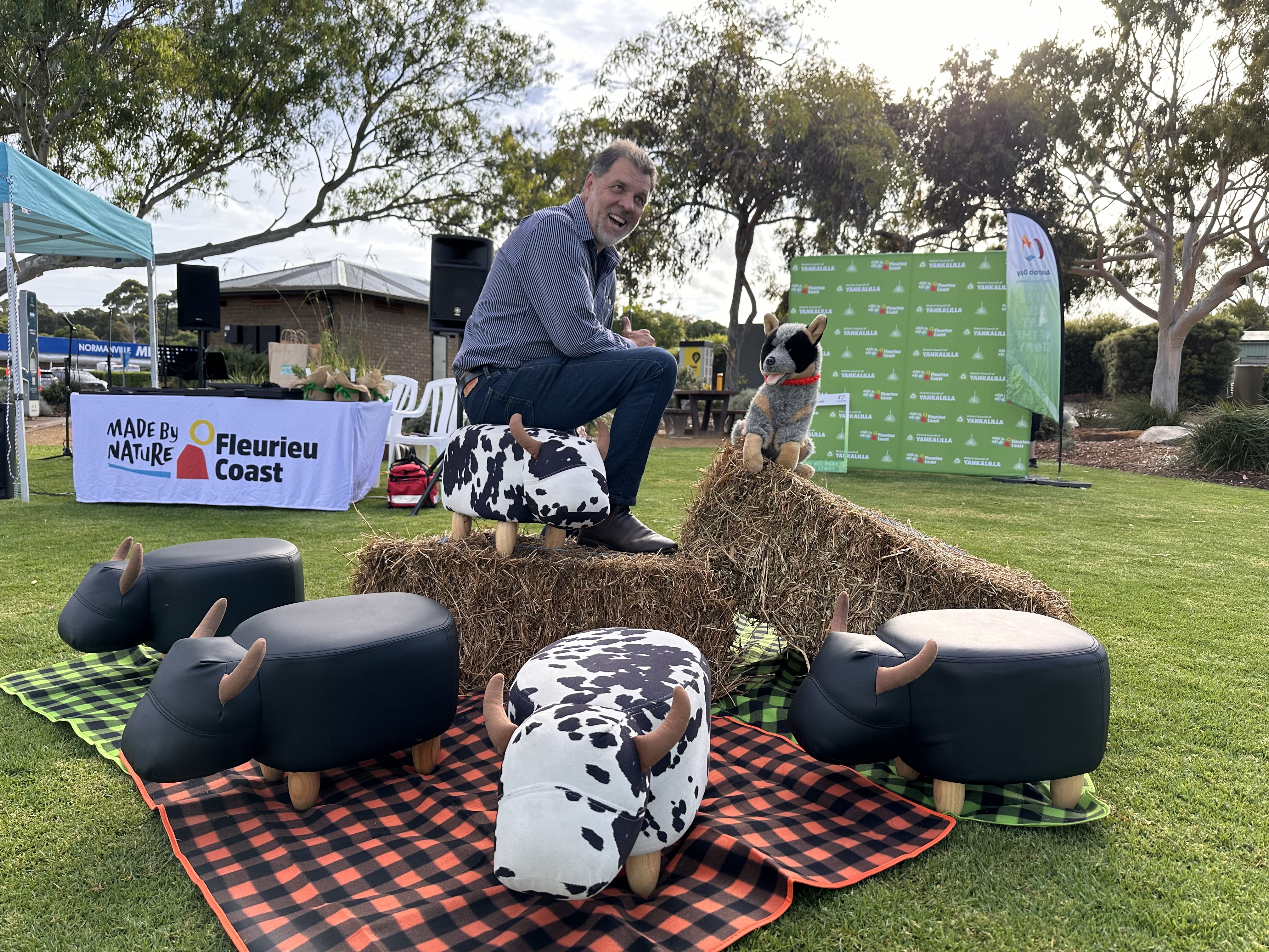 Mayor Houston sitting on a pile of toy cows