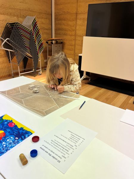 Mila (a little girls) creating a 3D Under the Sea masterpiece at the library